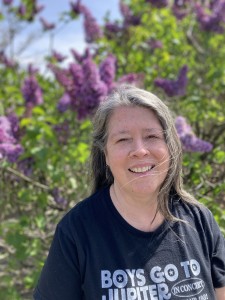 Eileen in front of lilacs at the New York Botanical Gardens