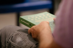 Hands holding the book Common Ground